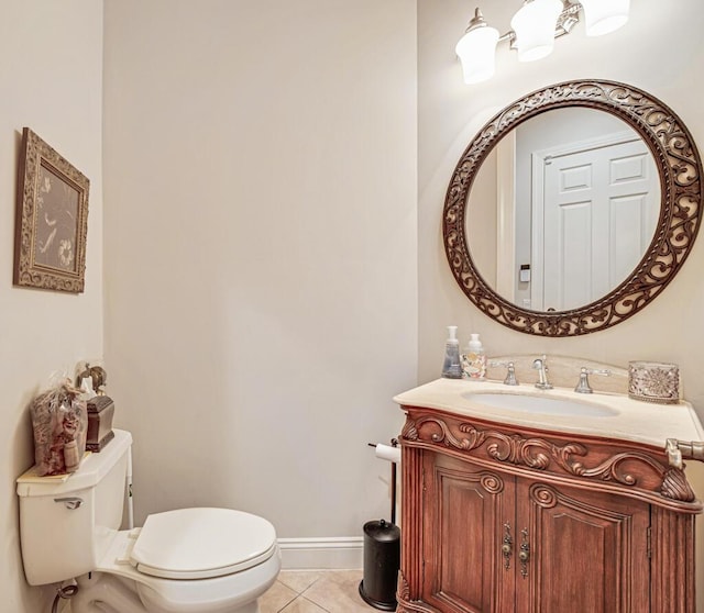 half bath with vanity, tile patterned floors, toilet, and baseboards