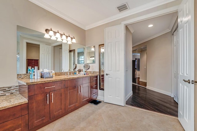 full bathroom featuring vanity, crown molding, visible vents, and tile patterned floors