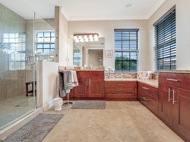 bathroom with tile patterned floors, vanity, a stall shower, and crown molding