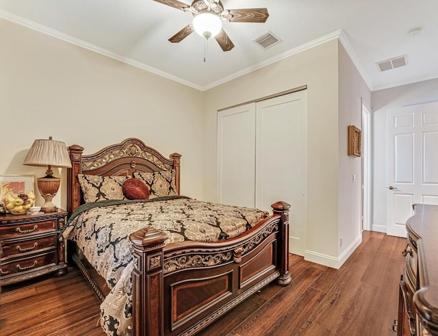 bedroom featuring visible vents, baseboards, a closet, ornamental molding, and dark wood-style floors