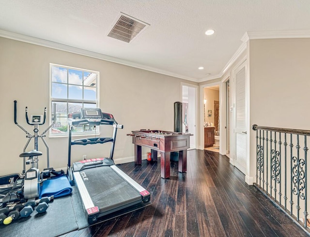 playroom featuring crown molding, baseboards, visible vents, and wood-type flooring