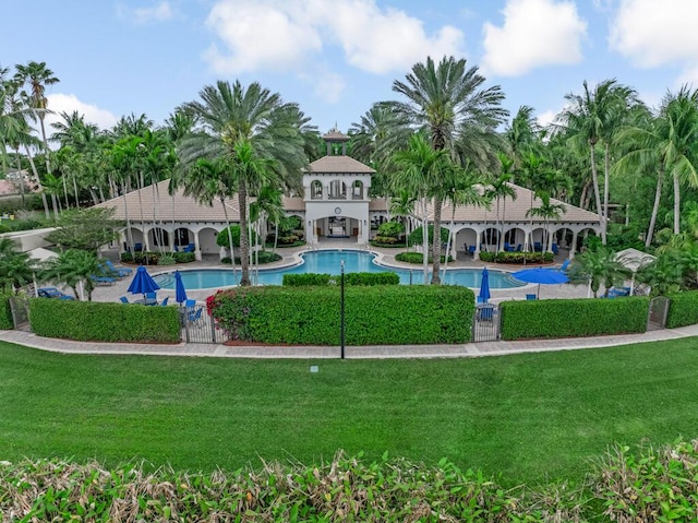 pool featuring a yard and a patio