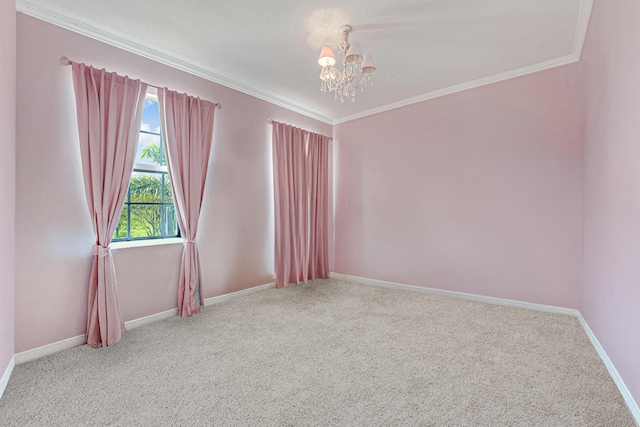 carpeted empty room featuring a chandelier, crown molding, and baseboards