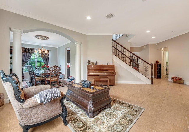 tiled living room with stairs, baseboards, visible vents, and ornate columns