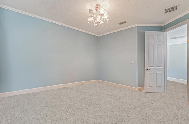 carpeted spare room with visible vents, baseboards, an inviting chandelier, and crown molding