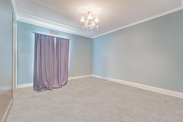 empty room with a notable chandelier, carpet flooring, a textured ceiling, and ornamental molding