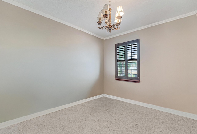 carpeted empty room with a notable chandelier, baseboards, and ornamental molding