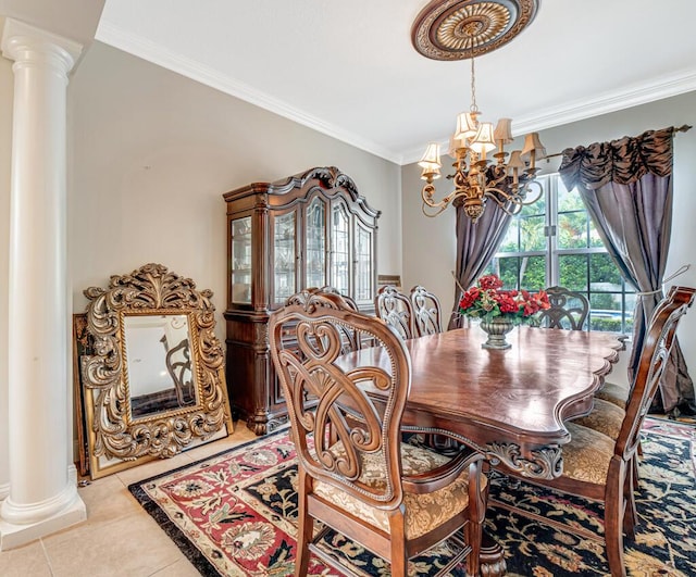 tiled dining room featuring decorative columns, a chandelier, and crown molding