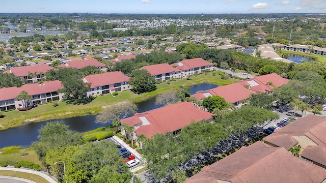 drone / aerial view featuring a residential view and a water view
