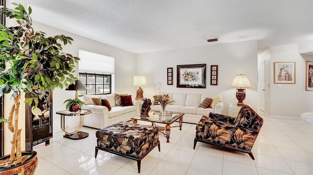tiled living area featuring a textured ceiling