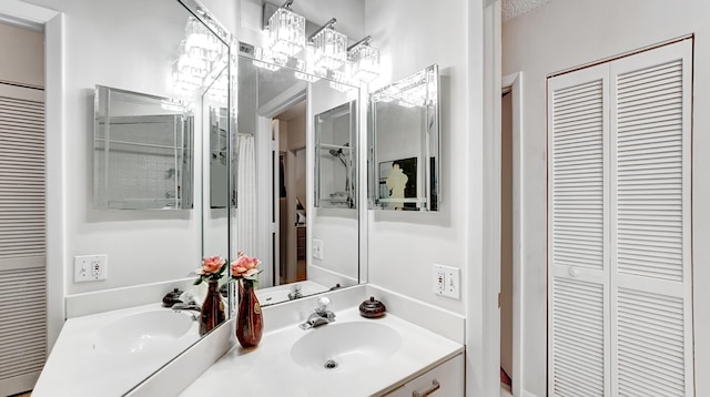 bathroom with double vanity, a closet, and a sink