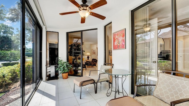sunroom featuring ceiling fan and plenty of natural light