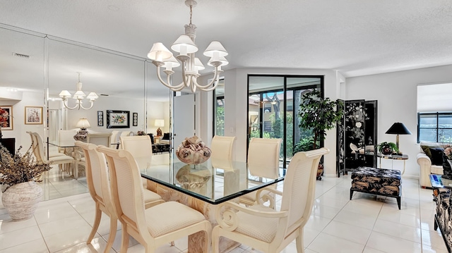 dining space with an inviting chandelier, light tile patterned flooring, and visible vents