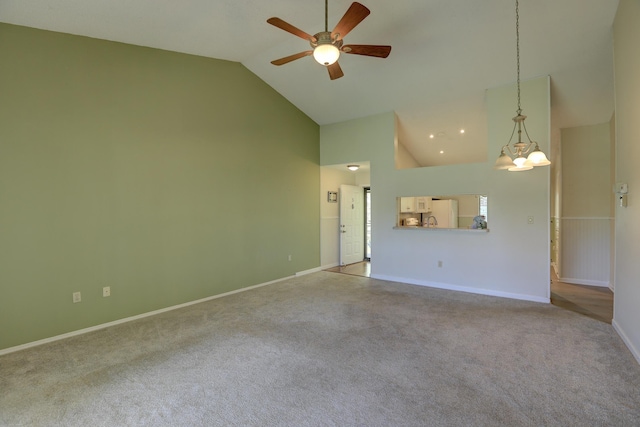 unfurnished living room featuring baseboards, high vaulted ceiling, carpet flooring, and ceiling fan with notable chandelier