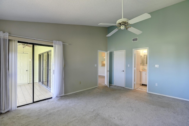 unfurnished bedroom with visible vents, ensuite bath, a textured ceiling, access to outside, and carpet flooring