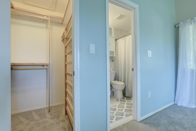 interior space with a shower with shower curtain, visible vents, baseboards, and toilet