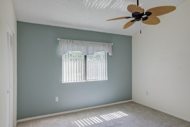 unfurnished room featuring ceiling fan, carpet, baseboards, and a textured ceiling