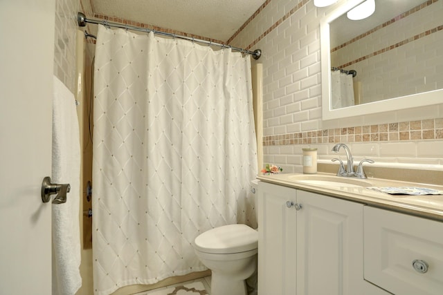 bathroom featuring vanity, decorative backsplash, and toilet