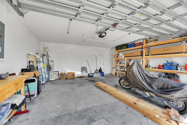 garage featuring concrete block wall and a garage door opener