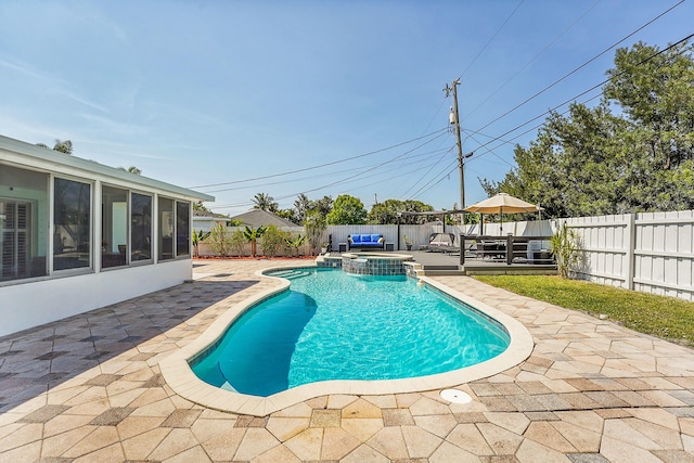 view of pool featuring a patio, a sunroom, a fenced backyard, and a pool with connected hot tub