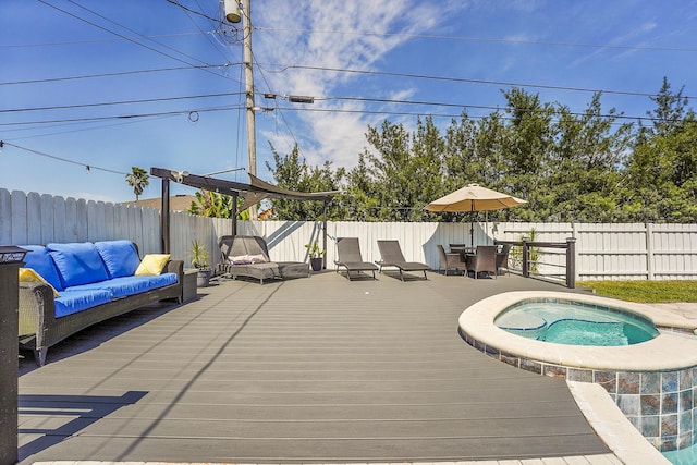 wooden terrace with a fenced backyard and an outdoor hot tub