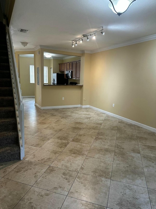 unfurnished living room with crown molding, stairway, baseboards, and visible vents