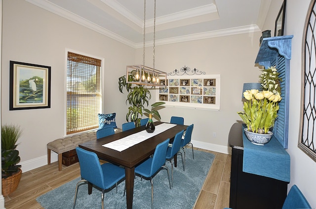 dining room featuring baseboards, crown molding, and wood finish floors