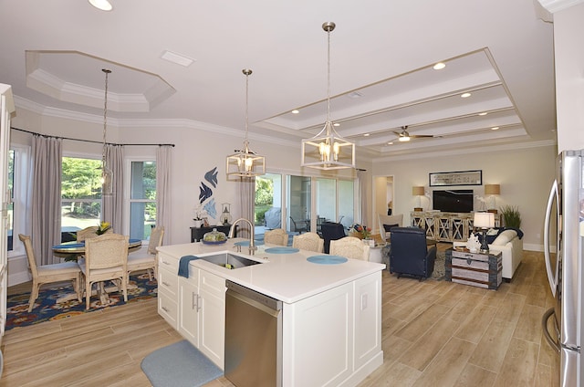 kitchen featuring a tray ceiling, white cabinetry, stainless steel appliances, and light wood finished floors