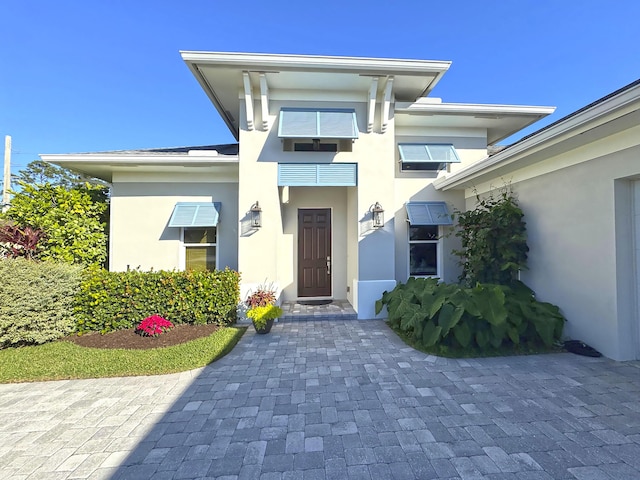 entrance to property with stucco siding