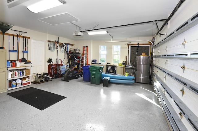 garage featuring a garage door opener and freestanding refrigerator