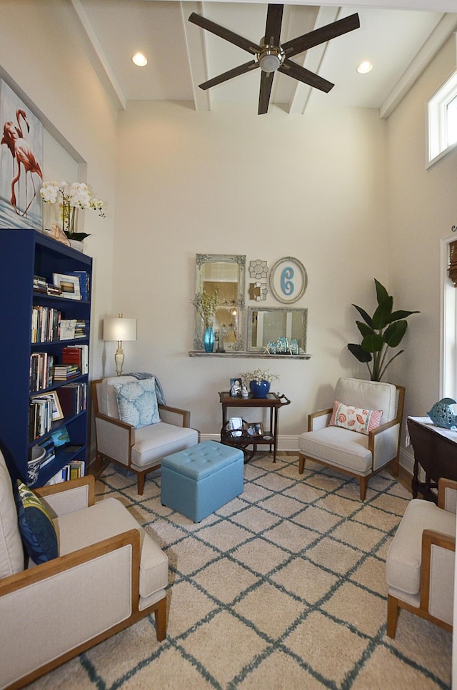 living room with baseboards, recessed lighting, a ceiling fan, and a towering ceiling