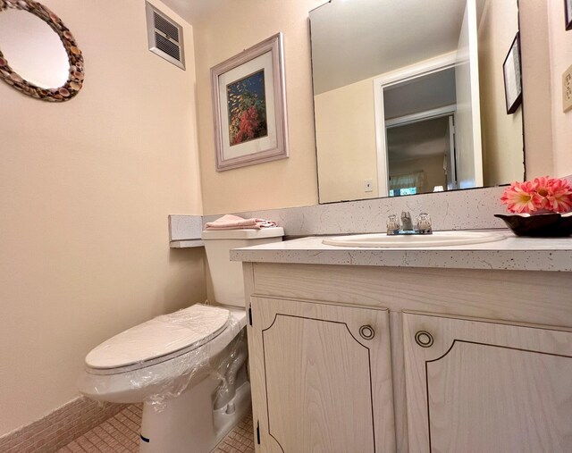 156 Bedford F, West Palm Beach, FL 33417 - bathroom with visible vents, toilet, and vanity