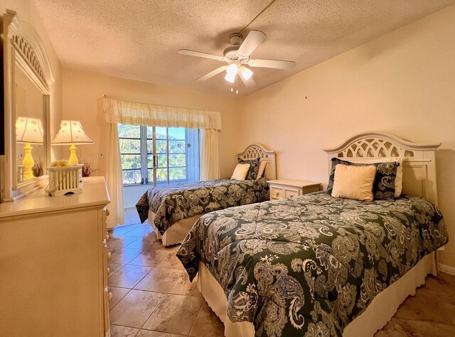 156 Bedford F, West Palm Beach, FL 33417 - bedroom featuring light tile patterned floors, a textured ceiling, and ceiling fan