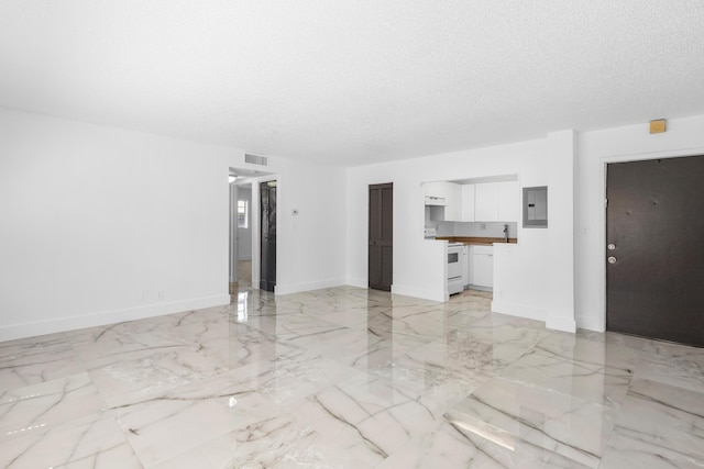 unfurnished living room featuring electric panel, visible vents, a textured ceiling, and marble finish floor