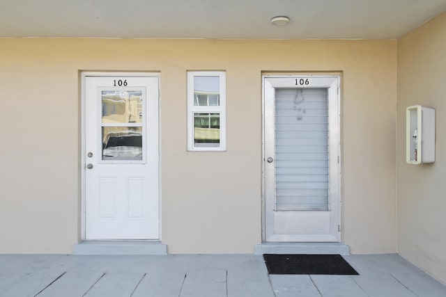 doorway to property with stucco siding