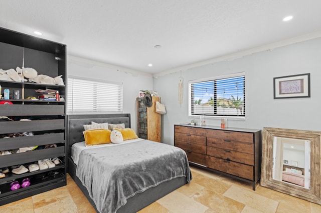 bedroom with stone finish flooring and recessed lighting