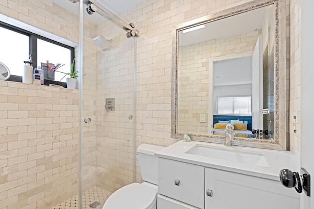 ensuite bathroom with ensuite bathroom, toilet, a shower stall, and vanity