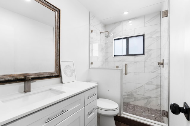 bathroom featuring recessed lighting, vanity, a stall shower, and toilet