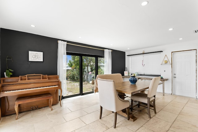 dining room featuring visible vents, recessed lighting, and stone tile flooring
