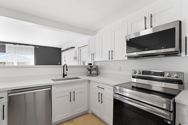 kitchen with a sink, light countertops, and appliances with stainless steel finishes