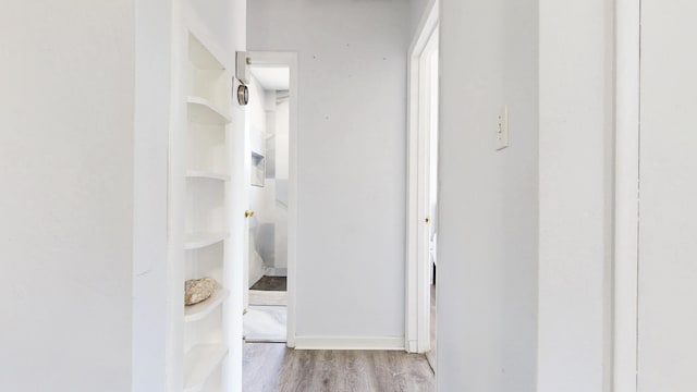 hallway with wood finished floors