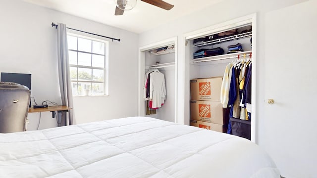 bedroom with two closets and ceiling fan