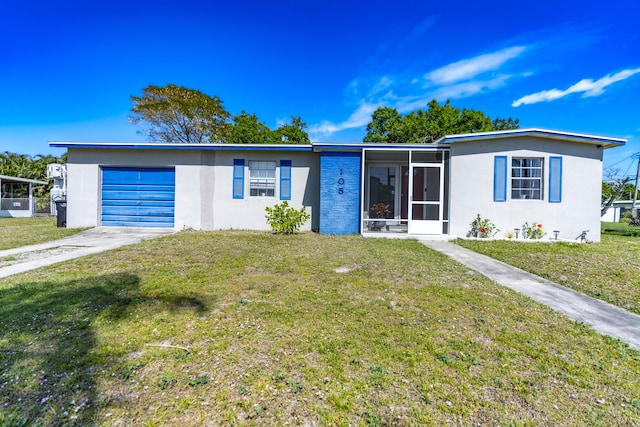 ranch-style home featuring a front lawn, concrete driveway, and a sunroom