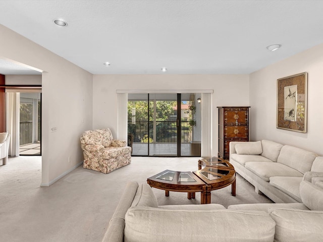 carpeted living room with baseboards