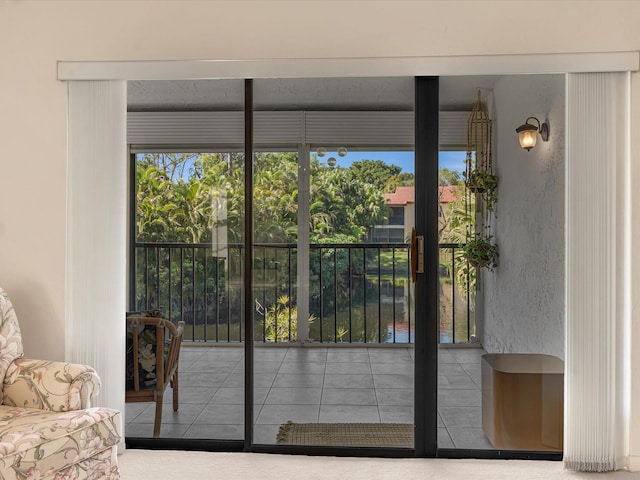 doorway to outside with tile patterned floors