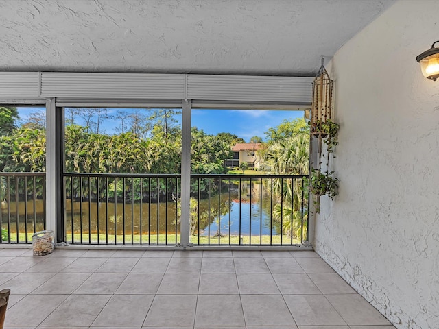 unfurnished sunroom featuring a healthy amount of sunlight and a water view