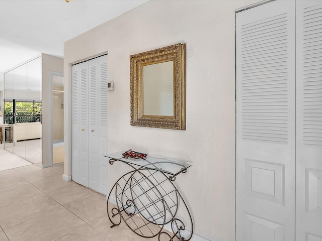 corridor featuring light tile patterned floors