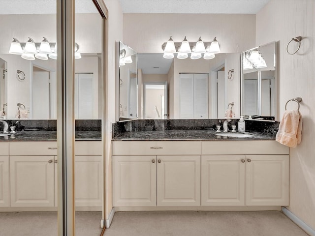 full bathroom with a closet and vanity