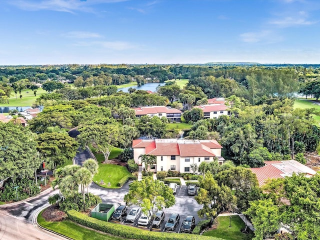 birds eye view of property with a forest view and a water view