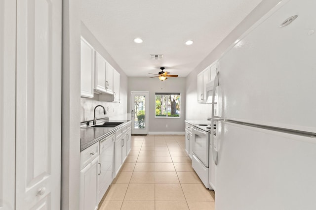 kitchen with white appliances, visible vents, light tile patterned flooring, a sink, and white cabinetry